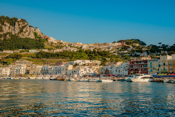 Capri harbor, full of colorful boats and houses.