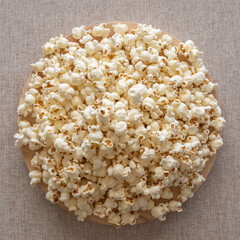 Popcorn on cotton fabric background. Top view.