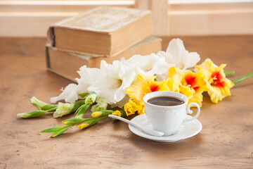 coffee and gladioluses on a table, selective focus