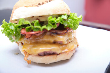 Double cheeseburger on a plastic tray