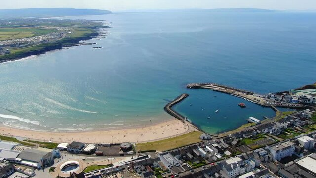 Aerial view on sandy Beach and coast of Atlantic Ocean in Portrush Northern Ireland, Top view on small coastal town 