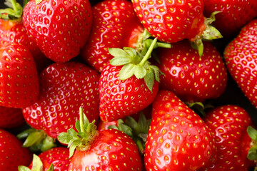 Background with bright red strawberries. Ripe summer berries.