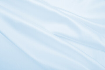 Smooth elegant blue silk or satin luxury cloth texture as abstract background. Luxurious background design