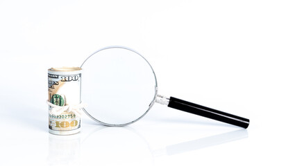 Magnifier glass and money with financial concept.