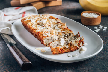 Coconut flour banana cake on dark background. Gluten free diet. Healthy food concept. Selective focus