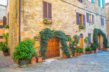 Street with an old house in Pienza, a town in the province of Siena, in the Val d'Orcia in Tuscany, Italy, Europe.