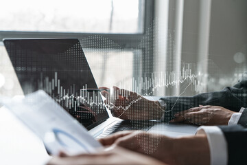 Two business people working together on stock market strategy. Try to analyze forex behavior....