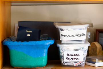 Personal & business receipts on dusty bedroom shelf from working at home.