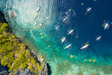 top down view of tourist boats close to big lagoon, aerial view. Tropical landscape. El Nido, Palawan, Philippines