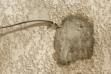 Wires of a rough stone wall with putty