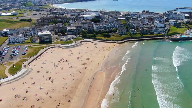 Aerial view on sandy Beach and coast of Atlantic Ocean in Portrush Northern Ireland, Top view on small coastal town 