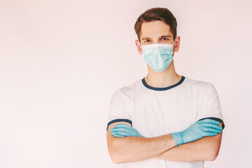 Fototapeta na wymiar Portrait young confident male doctor nurse in medical face mask and protective gloves keep arms crossed isolated on white background. Happy man surgeon in protective mask and medical gloves. COVID-19