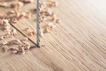 Fret saw cutting wooden oak plank. Jig saw cut clean timber plank.