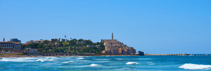 Alma beach in Tel Aviv-Yafo in a beautiful bright summer day people swimming in the blue ocean...