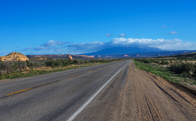 The road intersects the plain and rests against the mountains.