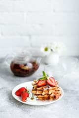 Delicious fresh baked belgian waffles with berries and fruit
