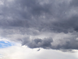 Heavy gray rain clouds in the blue sky. Atmosphere, air, cloudy, soon rain.