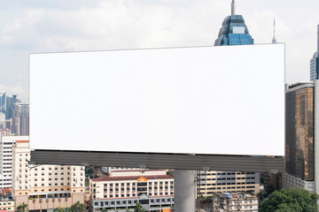 Fototapeta premium Blank white road billboard with KL cityscape background at day time. Street advertising poster, mock up, 3D rendering. Front view. The concept of marketing communication to promote or sell idea.