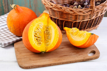 Man cuts a big pumpkin.