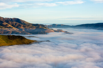 Silhouette of mountains in the misty morning. View of the mountains in early winter. Beautiful nature landscape. Bank Peninsula, Robinsons bay, Canterbury, Ndw Zealand.