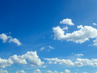 White fluffy clouds in the blue sky. Summer, cloudy. The air, the atmosphere.
