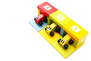 Educational toys for kids. Colorful wooden cars with numbers on white background