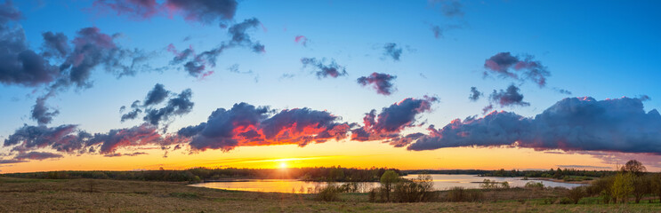 Fototapeta na wymiar Beautiful landscape with colorful sunset over forest lake