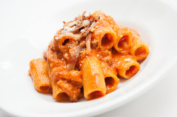 Pasta amatriciana with bacon e tomato sauce Roma cuisine, Italy, on white background