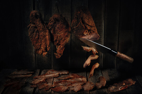 Homemade chicken breast basturma on a wooden background