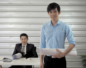  Architect or engineer or foreman hold blueprint is standing.