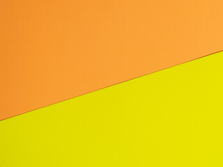 colored paper background in yellow and orange. Top view