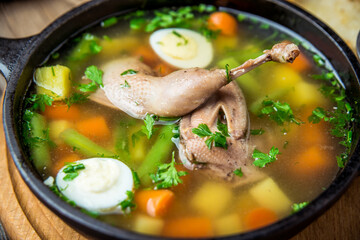 Soup with quail meat, with quail eggs and vegetables