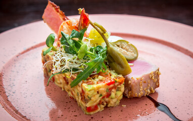 beautiful food: steak tuna in sesame, lime and fresh salad close-up on a plate