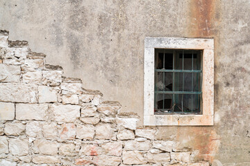 Fototapeta na wymiar Old grungy wall with trace of stair removed and window