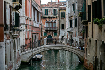 Fototapeta na wymiar horizontal photo of a small concrete bridge over a venetian canal