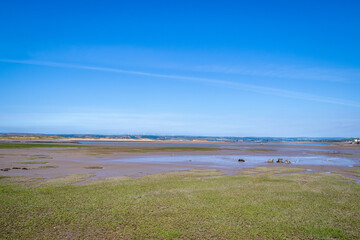 View across the wide and flat River Torridge and Taw estuary from Northam Burrows, Devon, UK. Low tide.