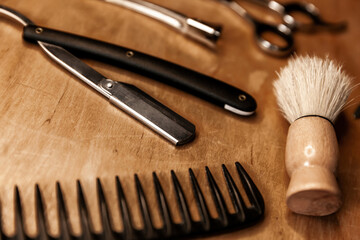 Shaving tools close up. The hairdressing tool lies on a wooden table.