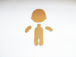 part of the body of a felt doll lie next to a white background

