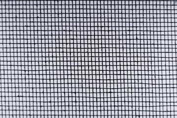 Blurred  Abstract Minimal style black and whith rays of sunlight cast shadows on the wire mesh steel metal
