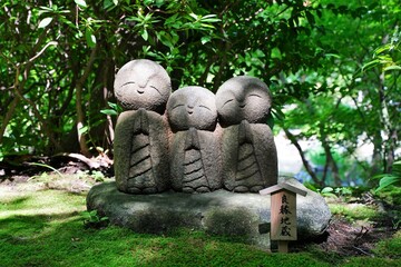 Japanese text is "Ryoen Jizo". "Ryoen" means Good relations and "Jizo" means Guardian deity of children, Stone statue. At Hasedera temple in Kamakura Japan.