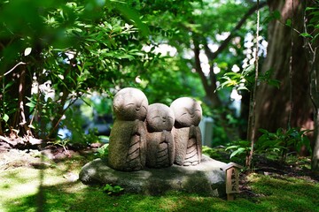 Japanese text is "Ryoen Jizo". "Ryoen" means Good relations and "Jizo" means Guardian deity of children, Stone statue. At Hasedera temple in Kamakura Japan.