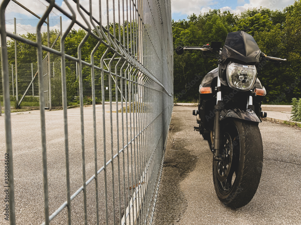 Wall mural Road black motorcycle on the road.