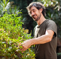Smiling man doing yard work.