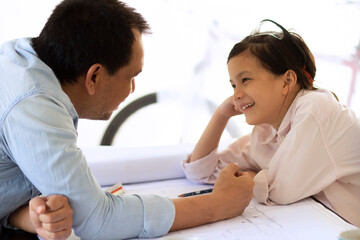 Obraz premium Soft focus image of Asian Father and daughter bonding.The happy time in garage workshop with plan and warm climate.Concept of Father and daughter relation