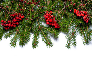 Spruce branches with rowan berries and Christmas decorations isolated on white background. Design template for New Year and Christmas.