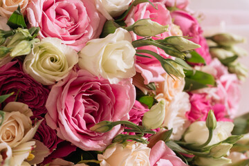 buds of white-pink roses and eustoma in a bouquet close-up