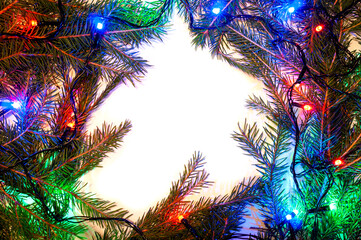Christmas background with spruce branches and colorful garlands. Design template for Happy New Year and Marry Christmas.