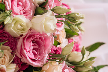 buds of white-pink roses and eustoma in a bouquet close-up