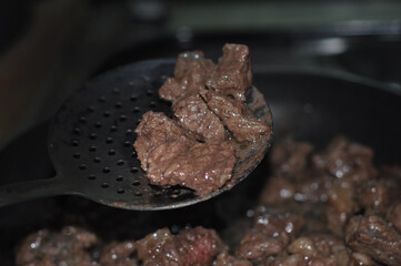 grilled beef meat in oil in a pan
