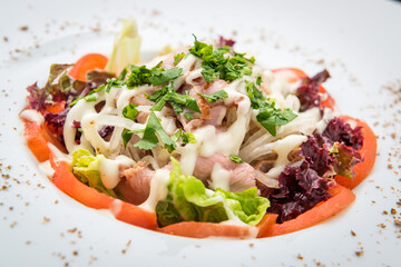 Chicken salad, Salad with meat and tomato on a plate